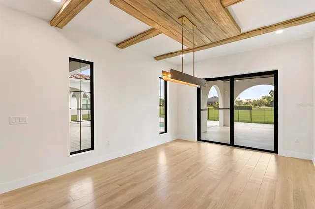 a view of room with window and wooden floor