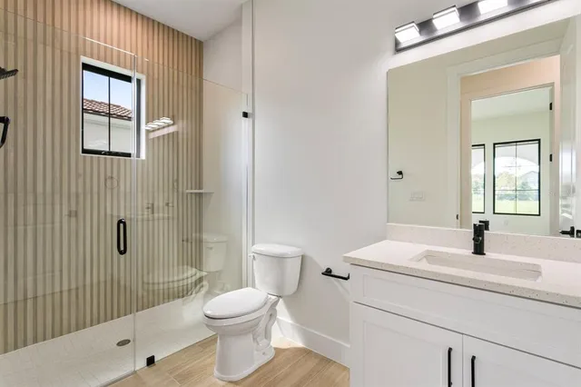 a bathroom with a sink toilet and shower