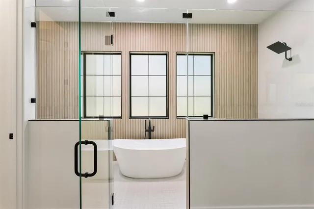 a bathroom with a bathtub and a shower