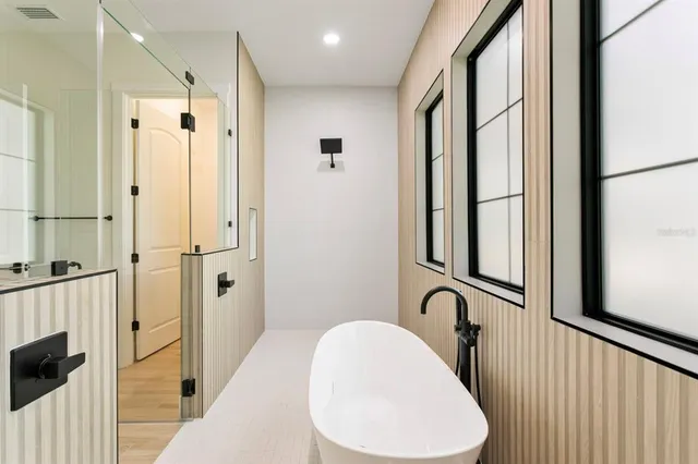 a bathroom with a bathtub and a shower