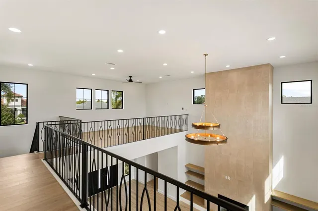 a view of a hallway with wooden floor and furniture