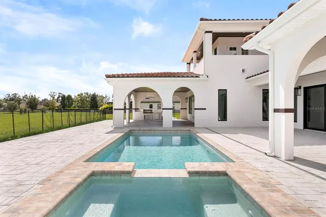a view of swimming pool with a outdoor seating