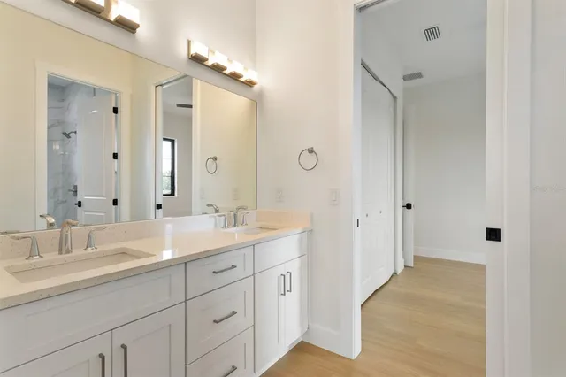a spacious bathroom with a double vanity sink mirror and double