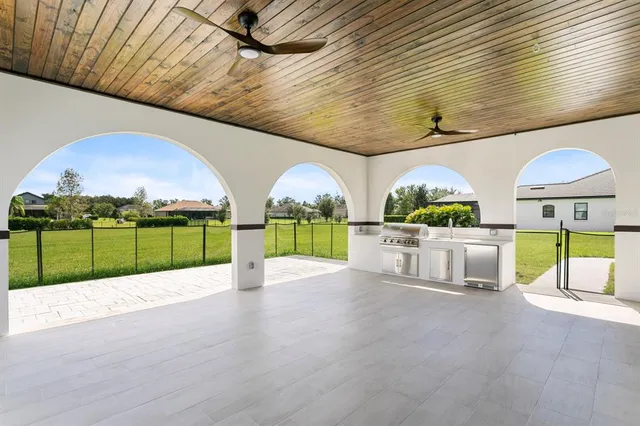 a kitchen with a stove and a white wooden cabinets