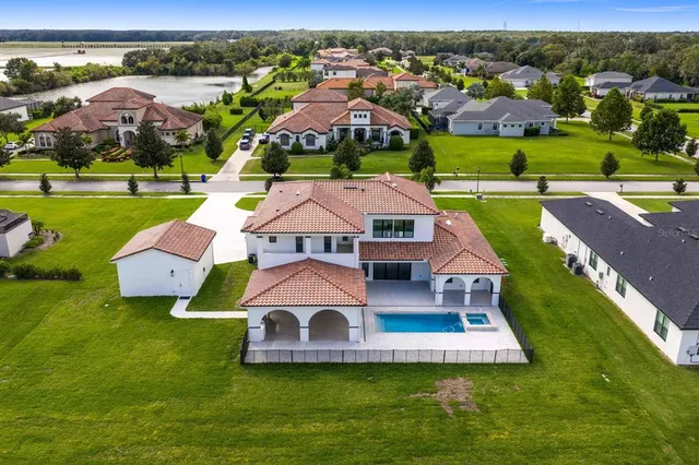 a view of a house with a yard and potted plants