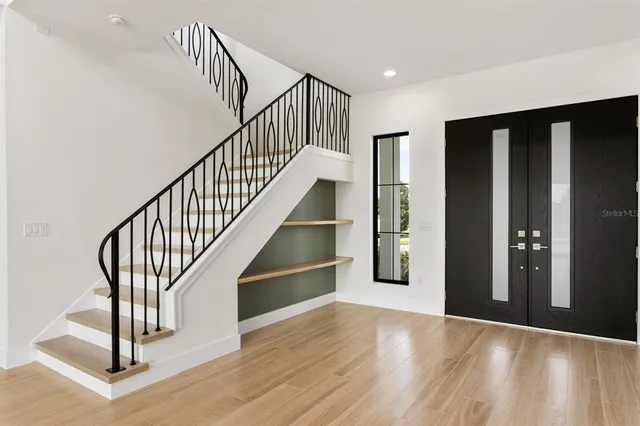 a view of entryway with wooden floor and stairs