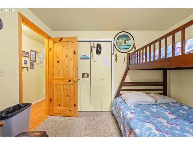 a bed sitting in a bedroom next to a window