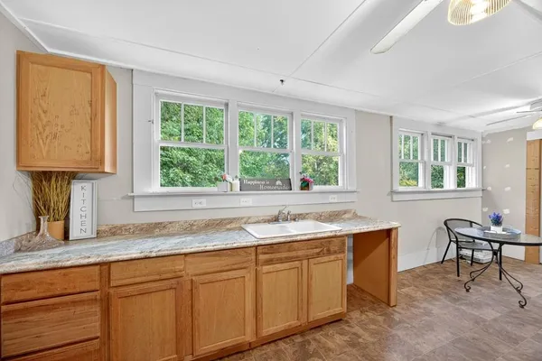 a kitchen with a sink stove and cabinets