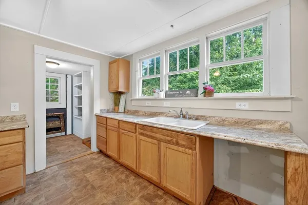 a kitchen with a sink cabinets and window