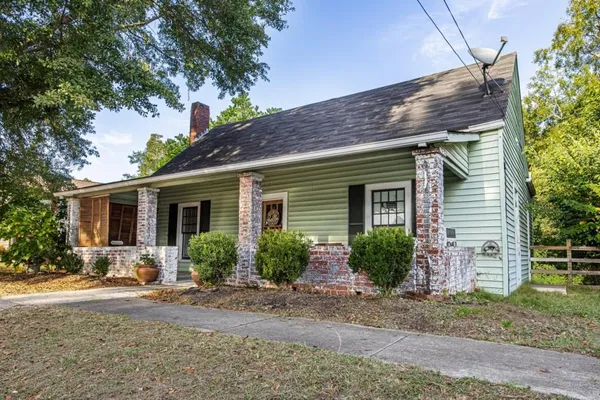 a front view of a house with garden