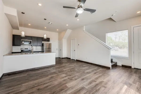 a bathroom with a granite countertop sink a mirror and shower