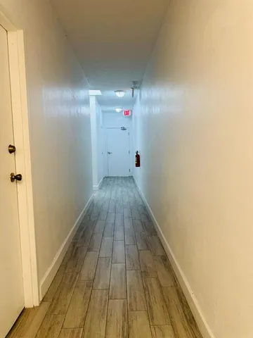 a view of a room with wooden floor