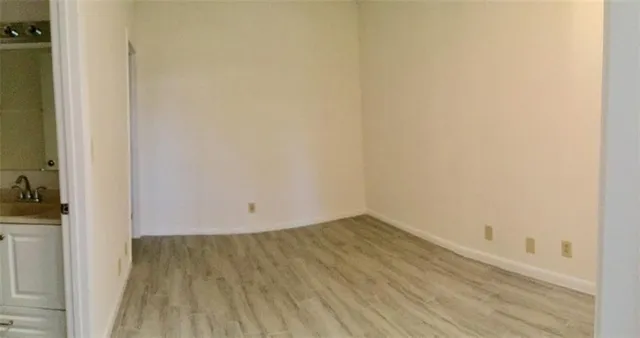 a kitchen with a refrigerator and a stove top oven