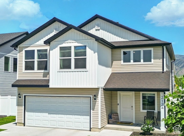 2124 1490 West Logan, UT 84339 - Photo 1 of 33 Townhome / multi-family property featuring a shingled roof, an attached garage, and driveway