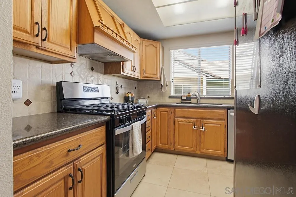 431 Nantucket Escondido, CA 92027 - Photo 13 of 30 a kitchen with stainless steel appliances granite countertop a sink a stove and a refrigerator