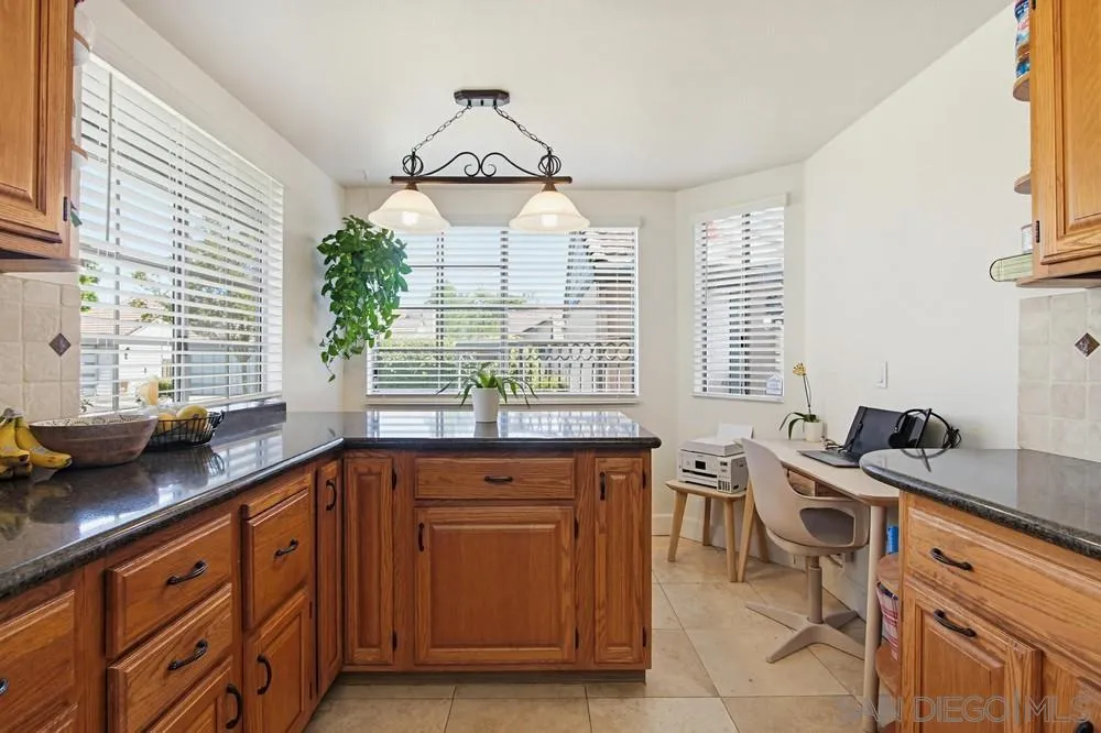 431 Nantucket Escondido, CA 92027 - Photo 18 of 30 a kitchen with stainless steel appliances a stove a sink and a window