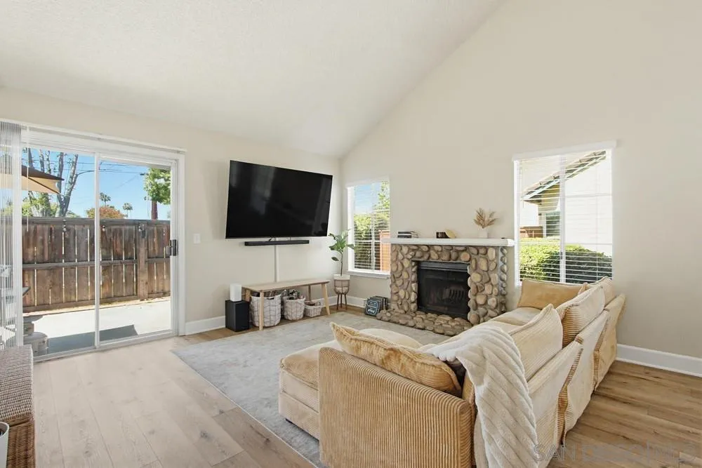 431 Nantucket Escondido, CA 92027 - Photo 10 of 30 a living room with furniture a fireplace and a flat screen tv