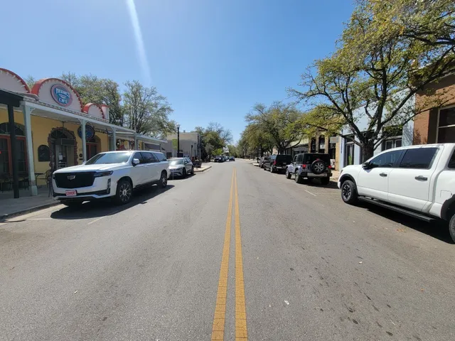 a view of street with parked cars