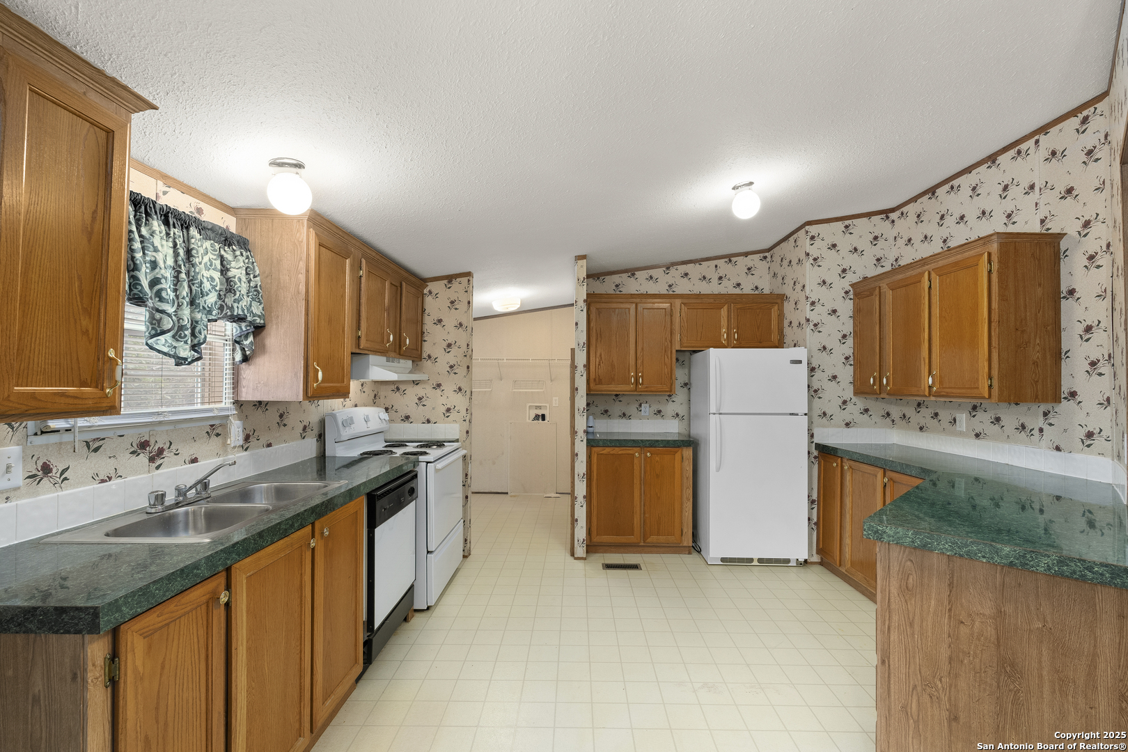 100 Haeckerville Road Cibolo, TX 78108 - Photo 18 of 31 a kitchen with a sink stove and refrigerator
