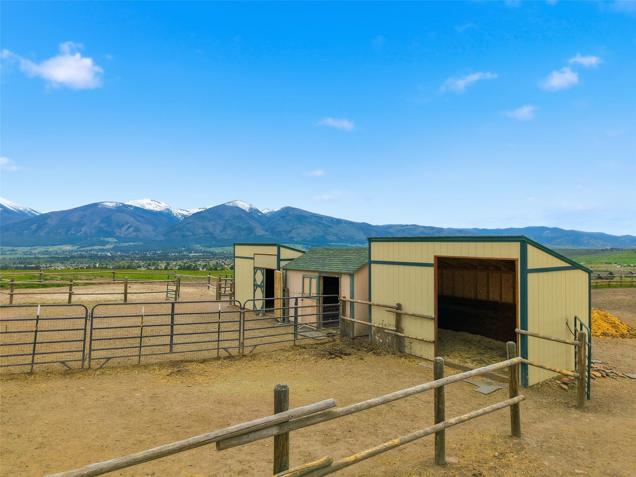 679 Hidden Valley Road North Florence, MT 59833 - Photo 71 of 85 Equestrian facilities featuring multiple fenced enclosures and two open-front shelters with pitched roofs
