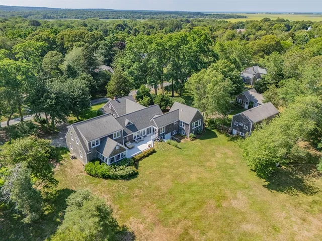 an aerial view of a house with a yard and lake view