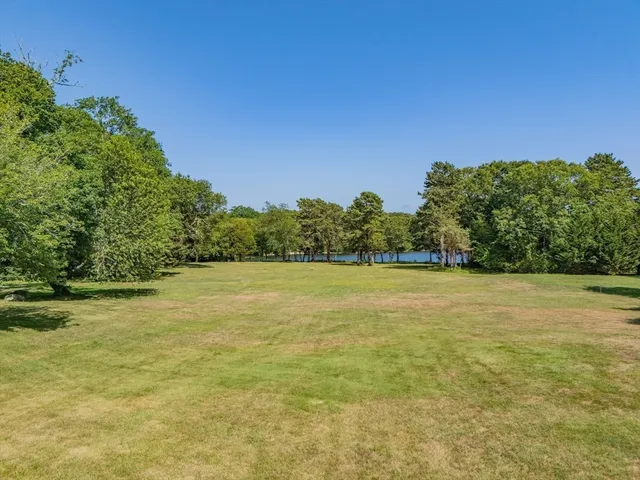 an aerial view of a house with yard and outdoor seating