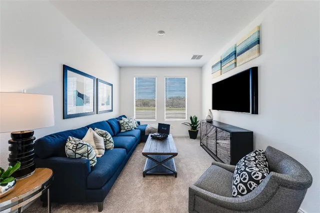 a living room with furniture fireplace and a flat screen tv