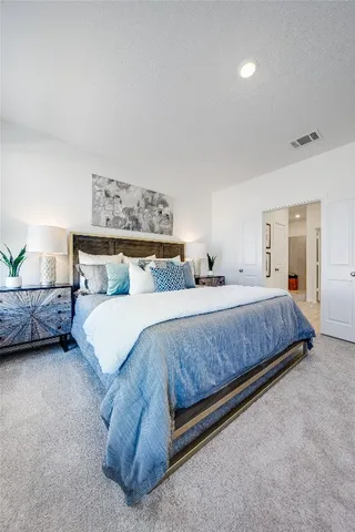 a bedroom with a bed and a night stand