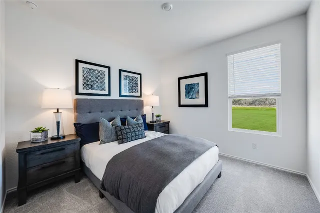 a bedroom with bed and a window