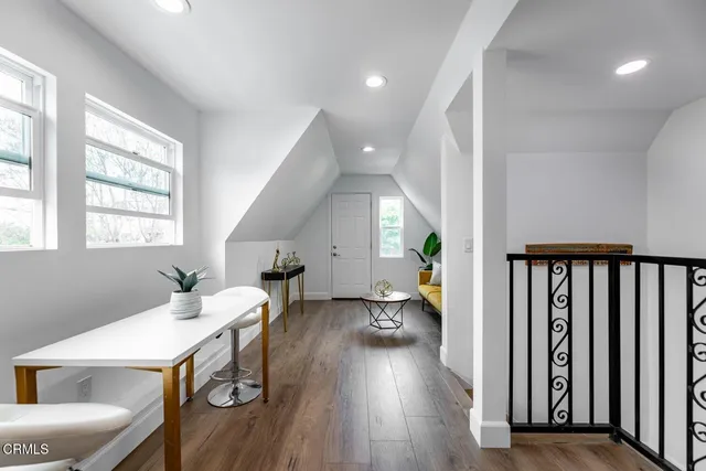 a living room with furniture a wooden floor and a window