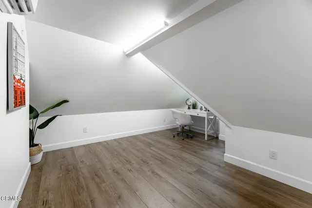 a view of entryway with stairs and wooden floor