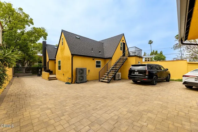 a view of car parked on the side of a street