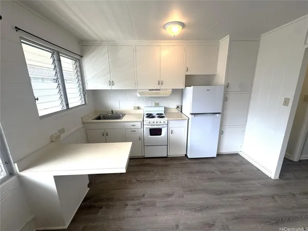 a white toilet sitting next to a bathroom sink