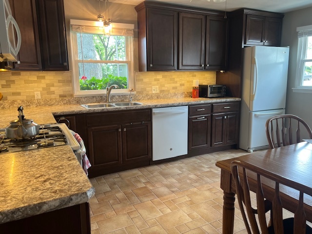 211 Koch Drive Genoa, IL 60135 - Photo 11 of 29 a kitchen with stainless steel appliances granite countertop a stove a refrigerator a sink a stove and island