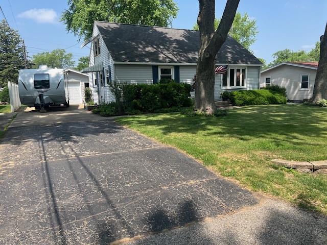 211 Koch Drive Genoa, IL 60135 - Photo 3 of 29 a front view of a house with a yard and garage