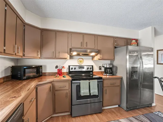 a kitchen with a stove and a refrigerator
