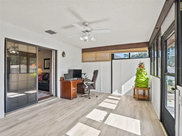 a living room with furniture and a floor to ceiling window