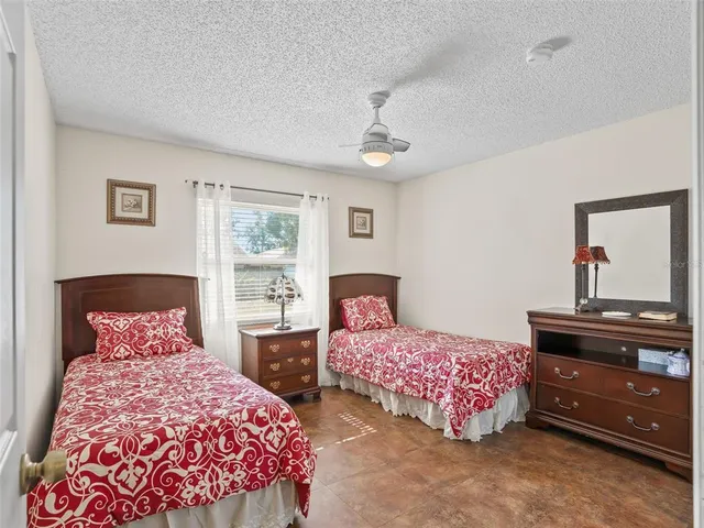 a bedroom with two beds and a dresser