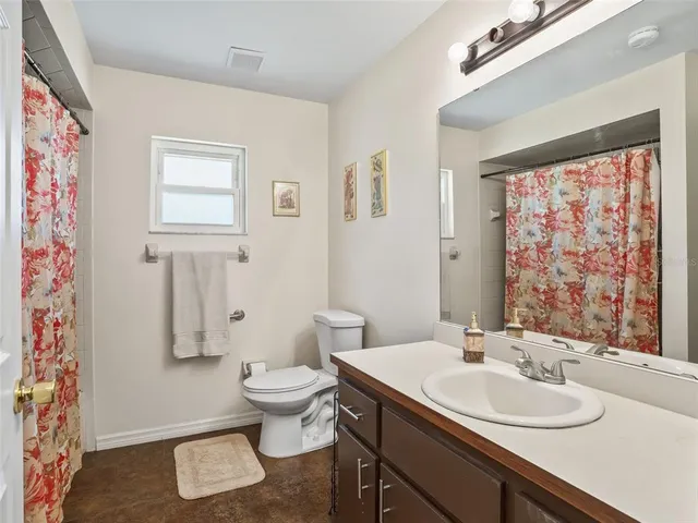 a bathroom with a sink toilet and a mirror