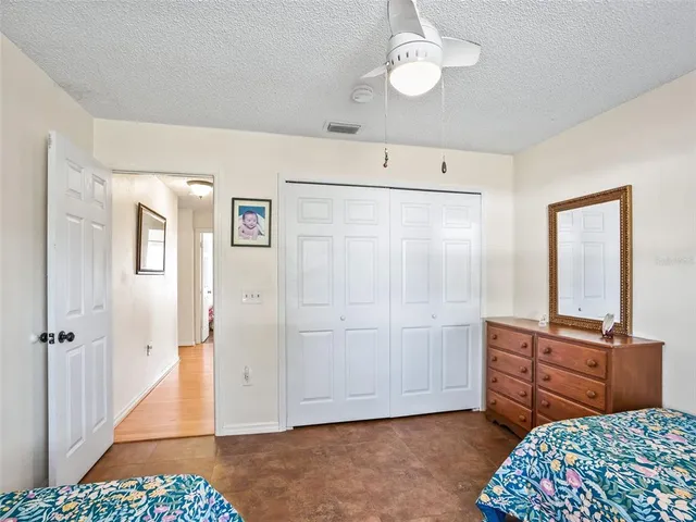 a view of a bedroom with closet and cabinet