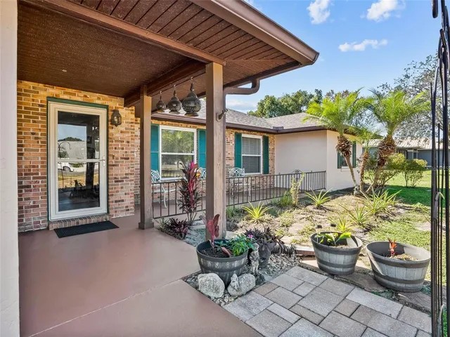 a view of a patio with chairs and plants
