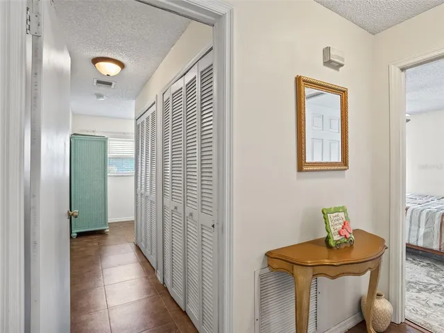 a view of hallway with livingroom and stairs