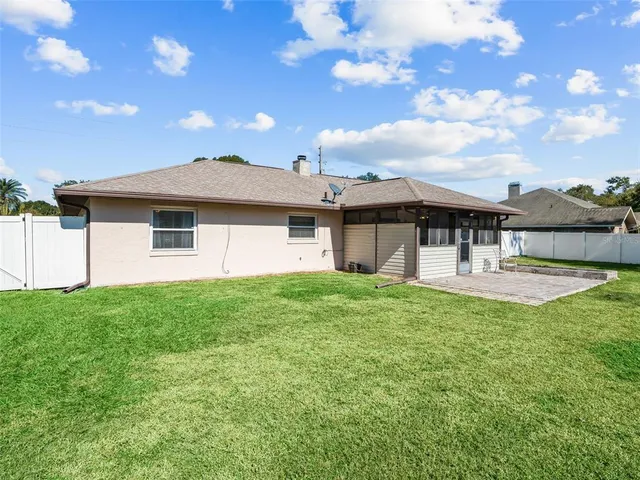 a view of a house with a backyard