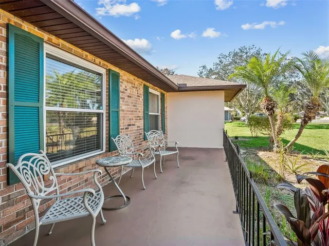 a patio with yard and outdoor seating