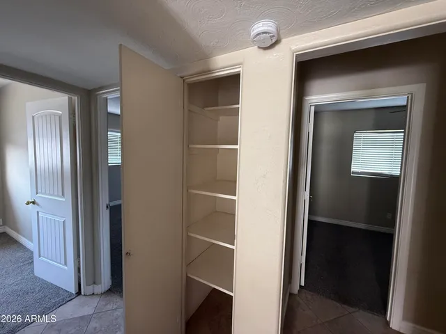 a view of hallway with bathroom