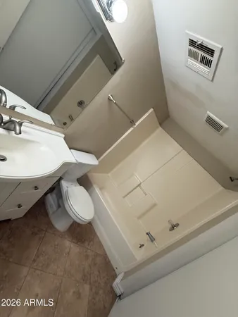 a large kitchen with a sink and white cabinets