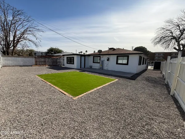 a view of a house with a backyard