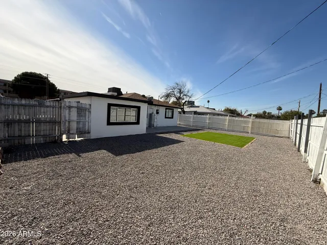 a view of a swimming pool with a patio and a yard