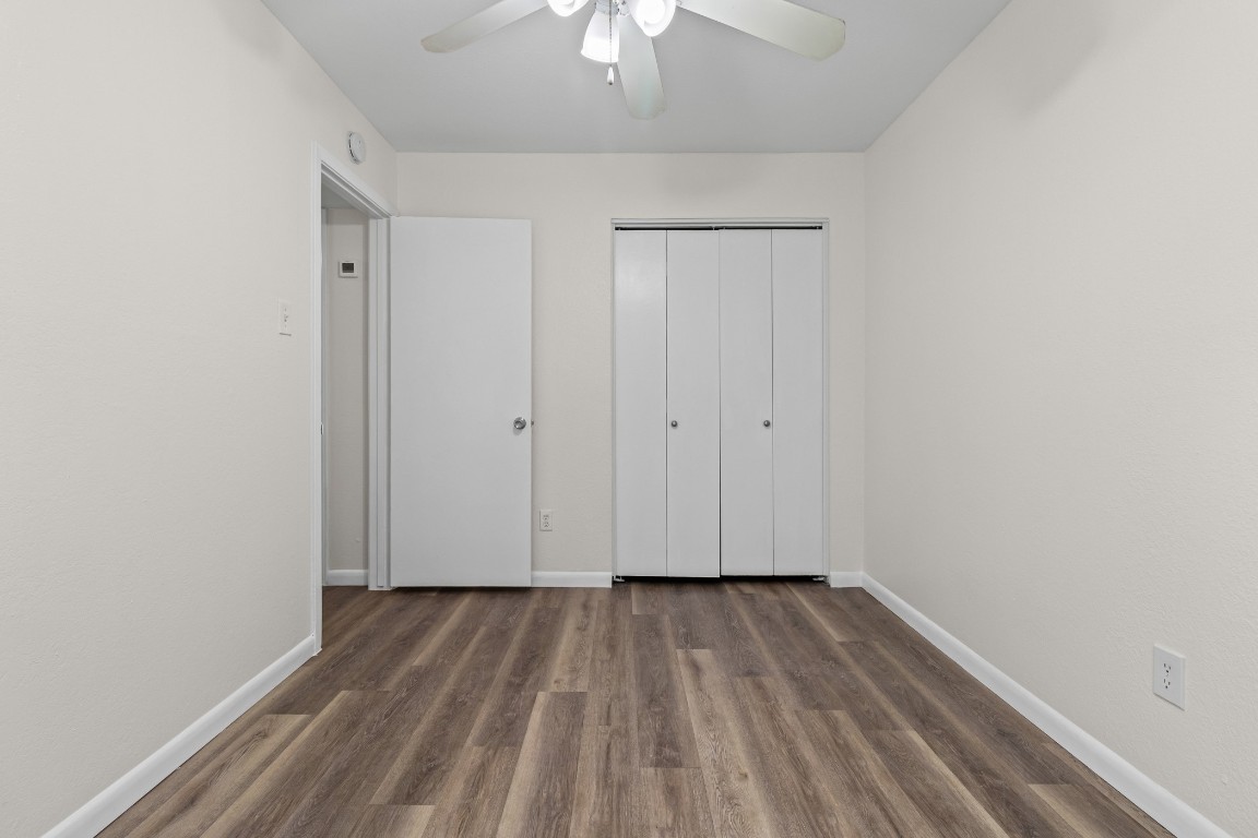 1713 Cinnamon Path, Unit B Austin, TX 78704 - Photo 14 of 32 a view of a room with wooden floor a ceiling fan
