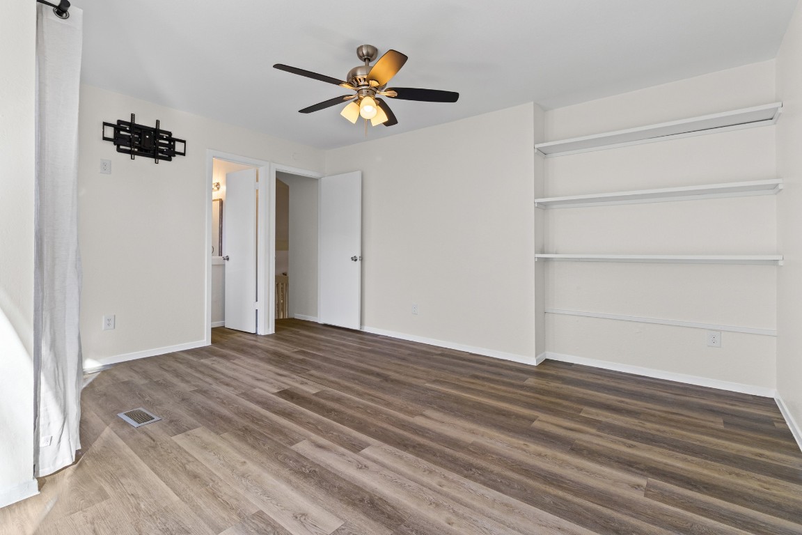 1713 Cinnamon Path, Unit B Austin, TX 78704 - Photo 16 of 32 a view of empty room with wooden floor and fan